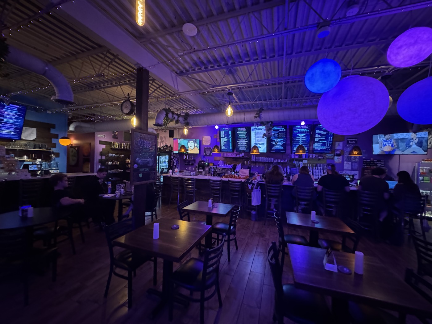 Kava and coffee bar counter with glowing menu boards and moon lamps at Moon Mountain Brandon
